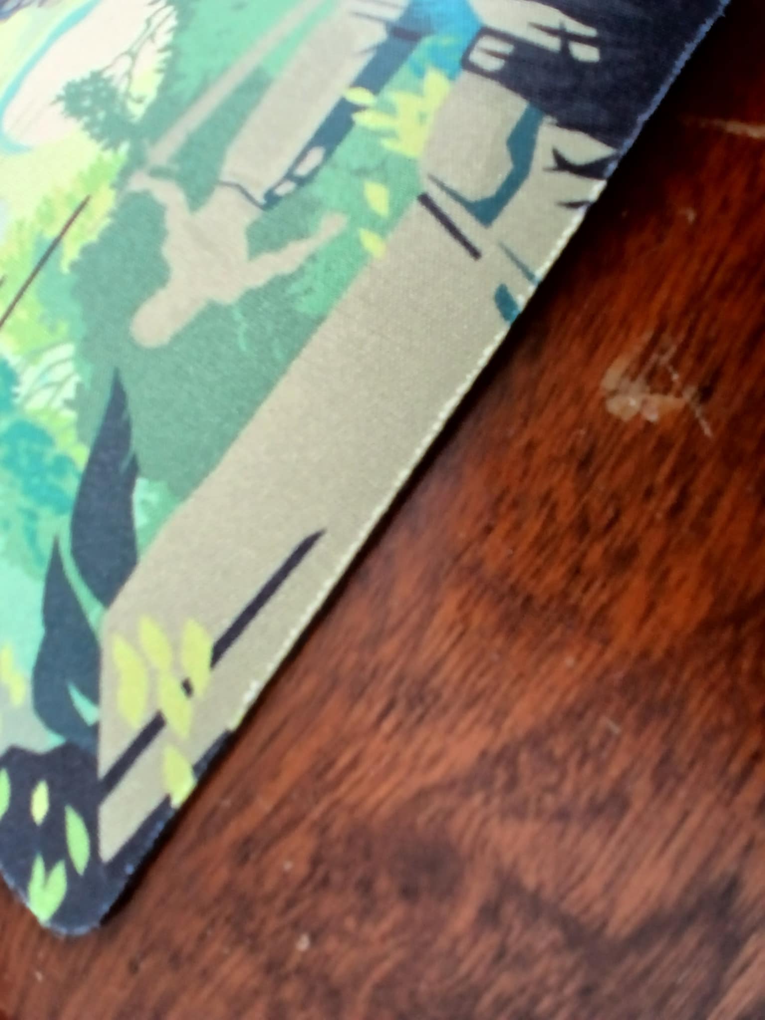 A photo of the edge ofa Regicide Legacy playmat. It has begun to fray slightly